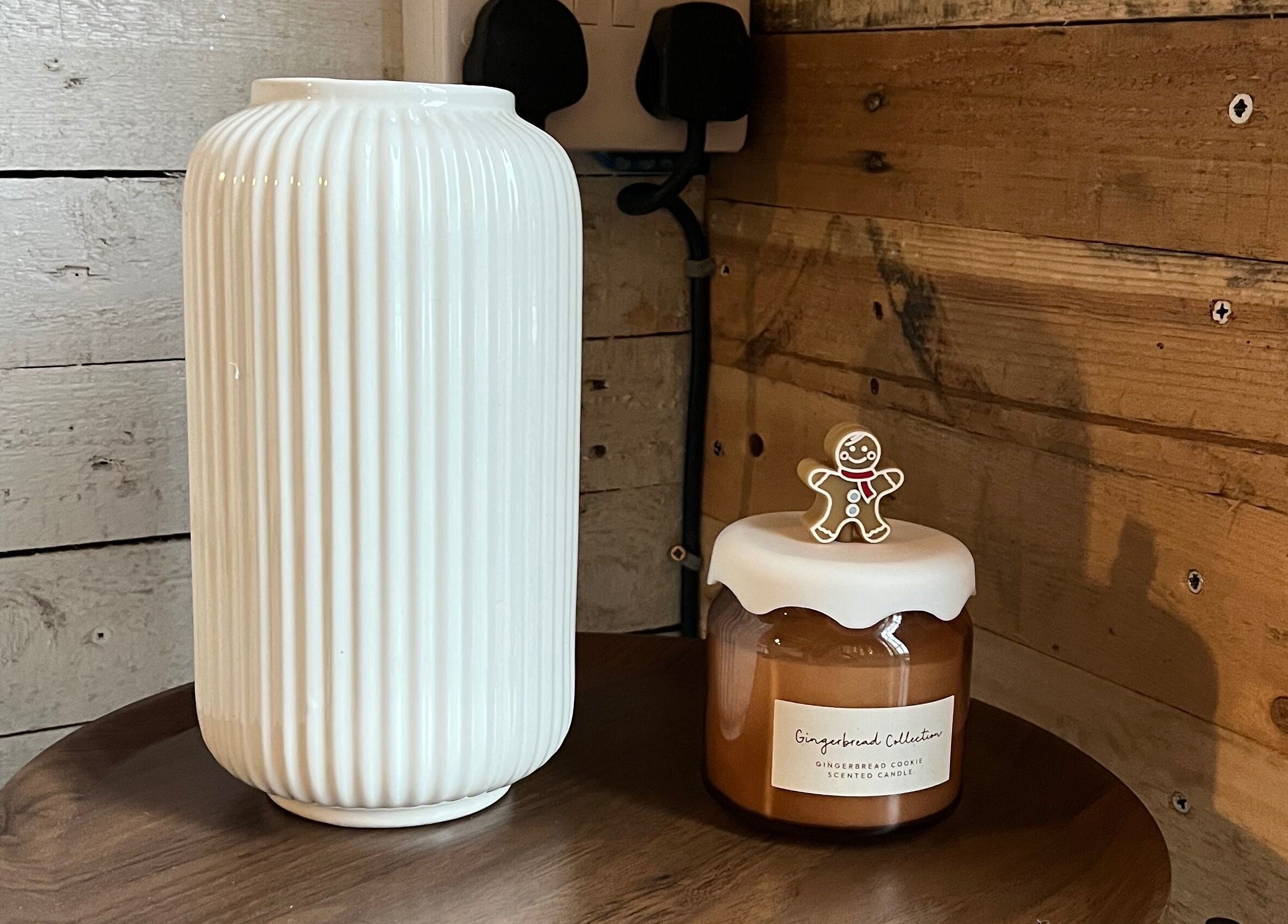 Warm rustic decor at Glow Nails, Bournemouth, England, GB with white vase and gingerbread candle.