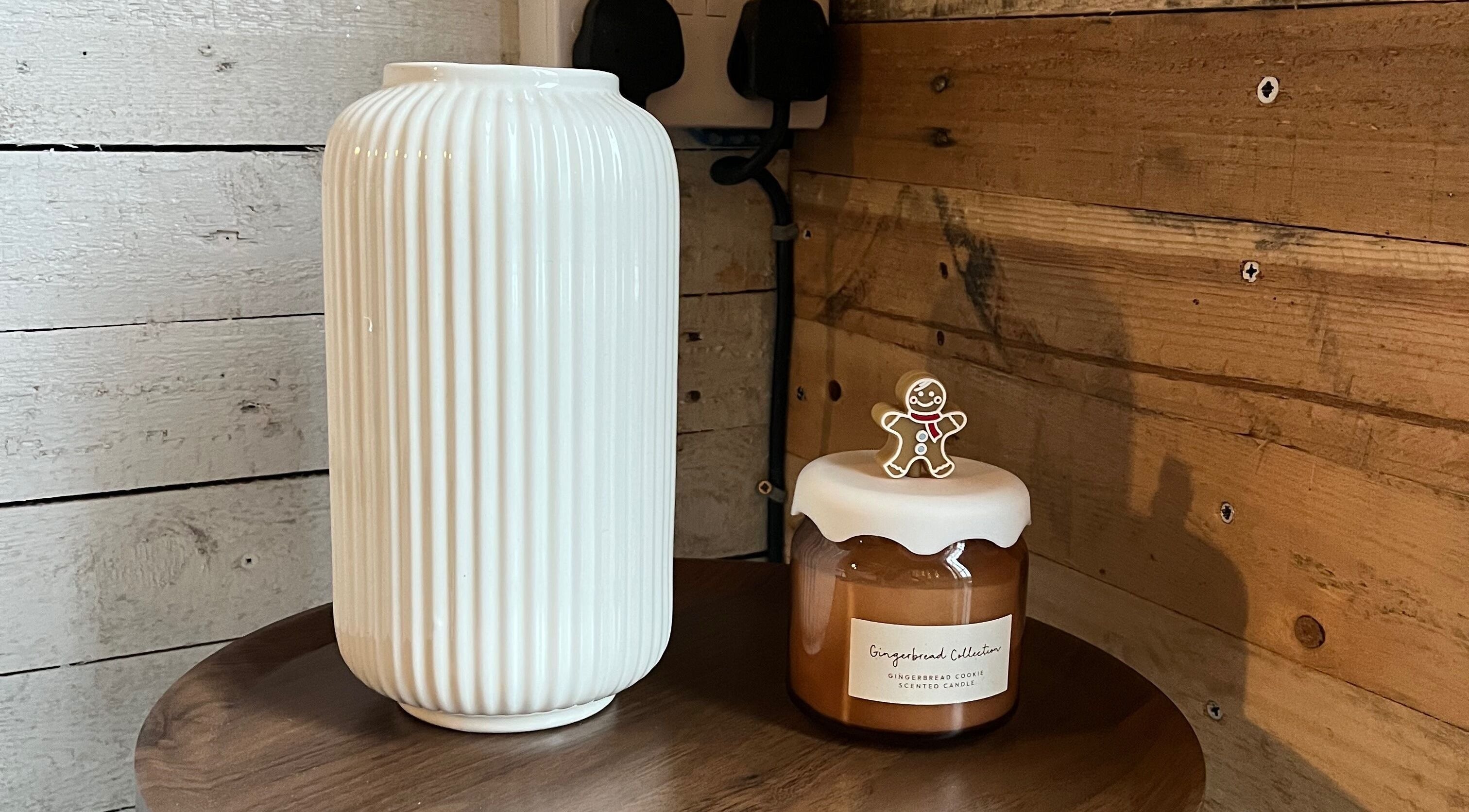 Warm rustic decor at Glow Nails, Bournemouth, England, GB with white vase and gingerbread candle.