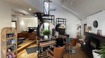 Elegant interior of DBuckshaw Hair salon in Regina, Saskatchewan, CA with modern decor and styling stations.