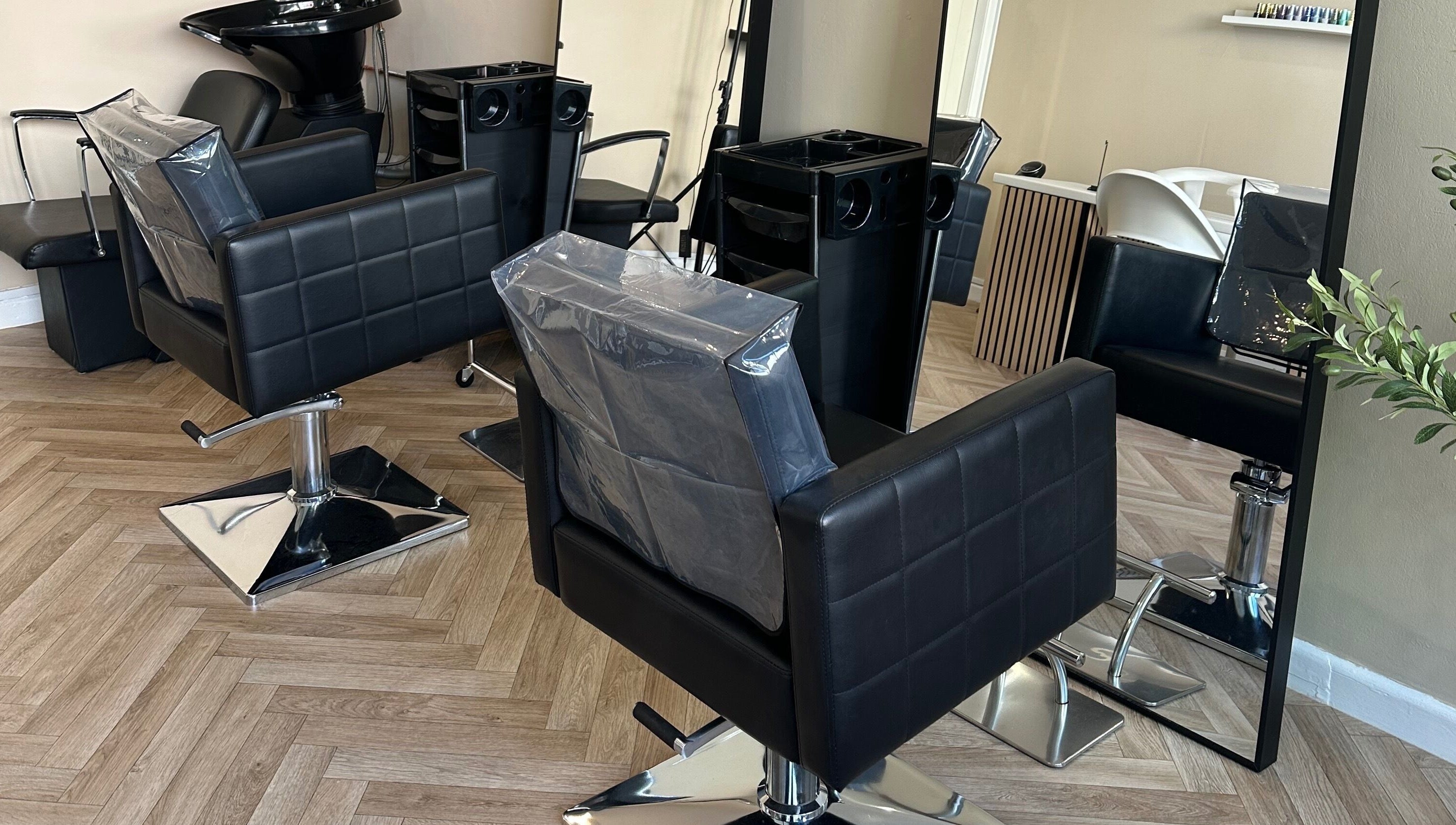Stylish salon chairs and mirror at Coley’s Beauty, Preston, England, GB. Modern and inviting atmosphere.