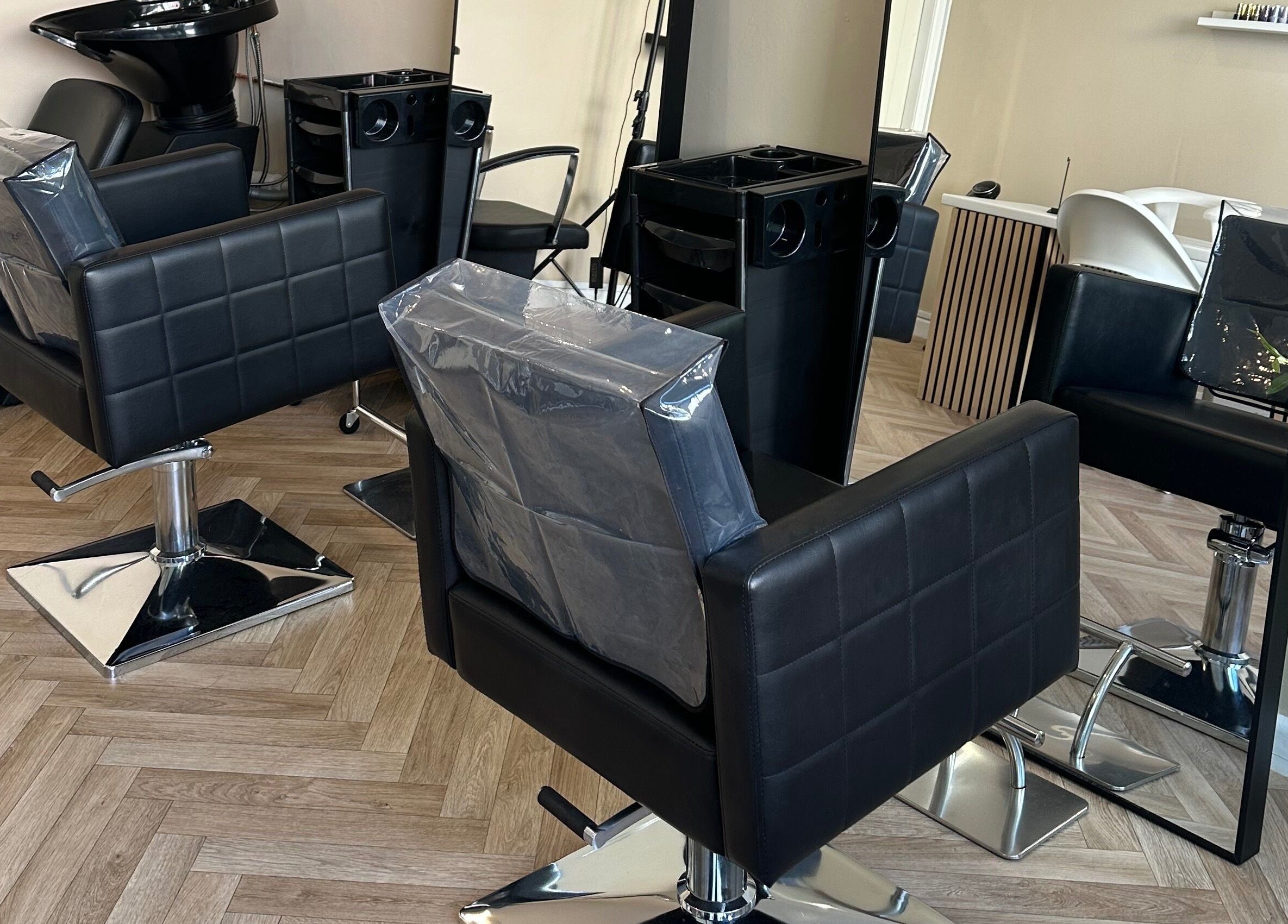 Stylish salon chairs and mirror at Coley’s Beauty, Preston, England, GB. Modern and inviting atmosphere.