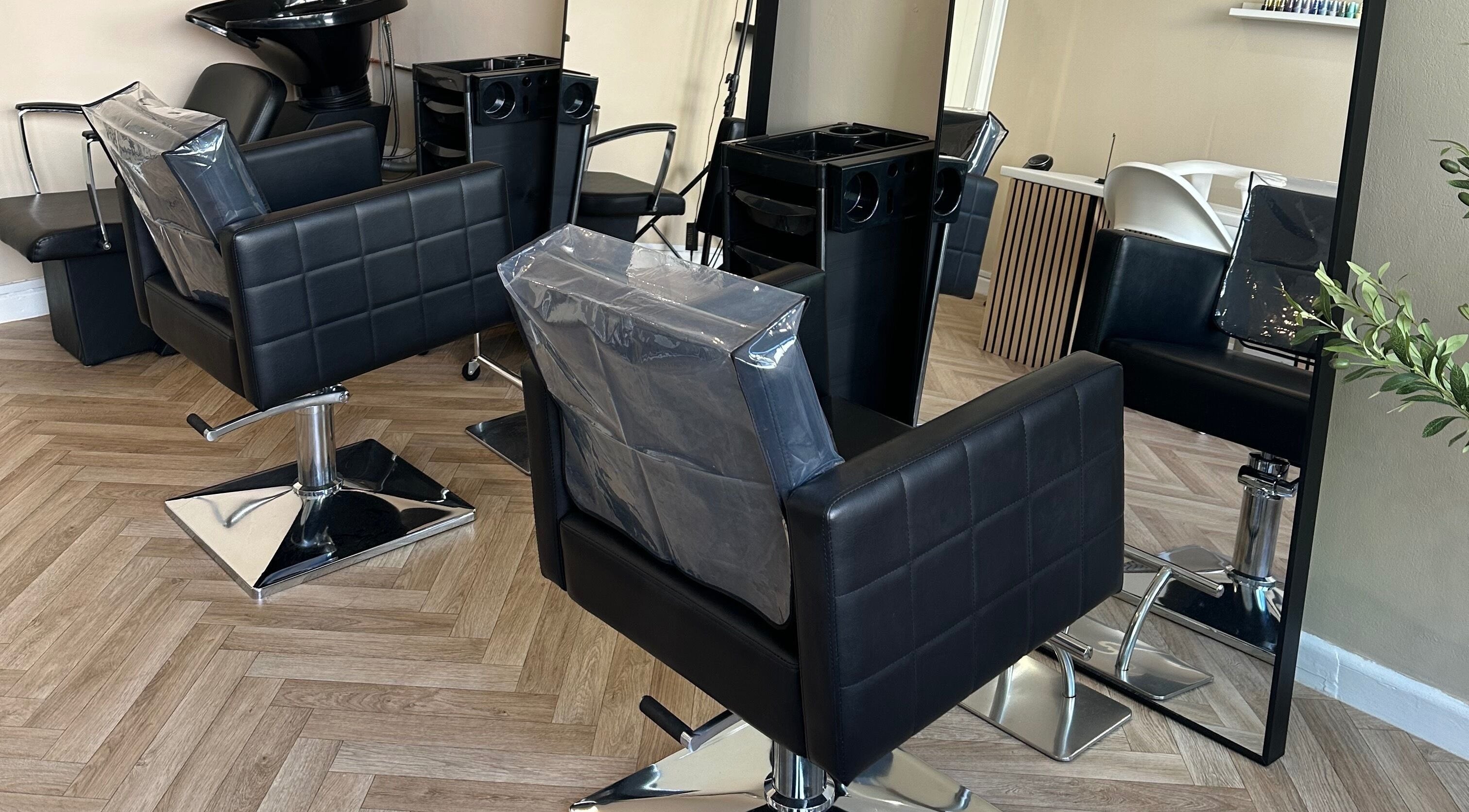 Stylish salon chairs and mirror at Coley’s Beauty, Preston, England, GB. Modern and inviting atmosphere.