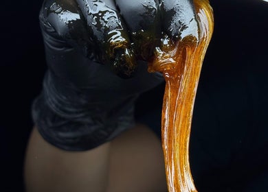 Sugaring paste in hand at Perle - Sugaring & Eye Beauty Treatments in Bali, Bali, ID, offers smooth beauty.