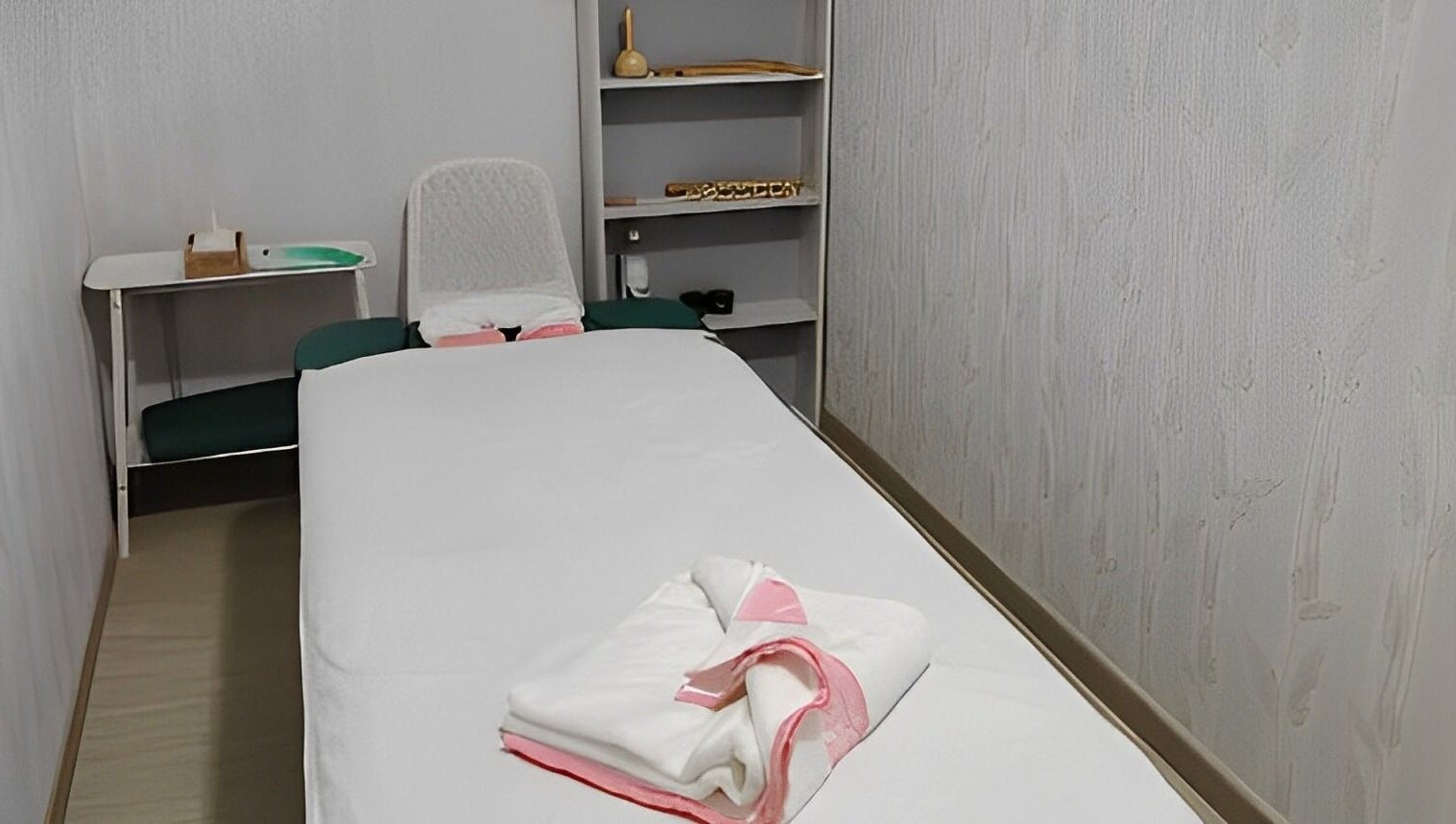 Relaxing massage room at TMH SALON & SPA, Doha, Doha Municipality, QA, featuring a cozy massage bed.