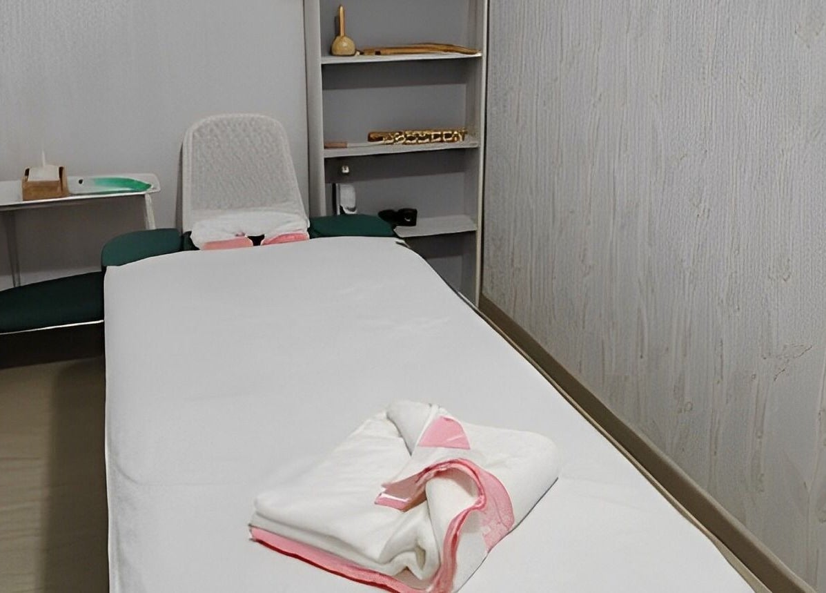 Relaxing massage room at TMH SALON & SPA, Doha, Doha Municipality, QA, featuring a cozy massage bed.