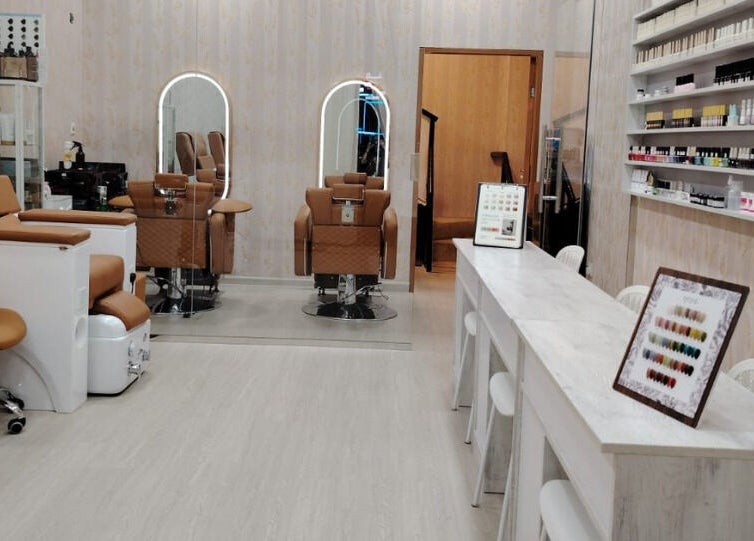 Chic interior of TMH SALON & SPA in Doha, Doha Municipality, QA with luxurious chairs and beauty products.