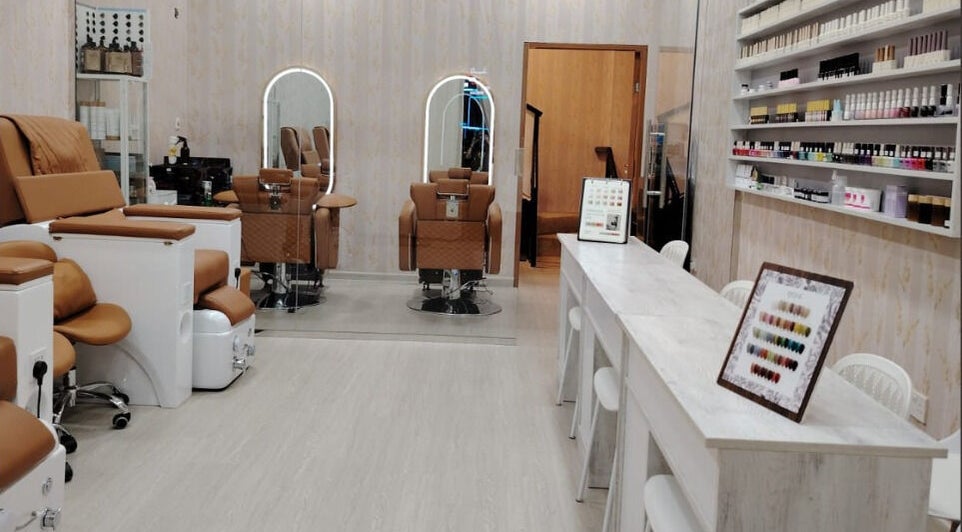 Chic interior of TMH SALON & SPA in Doha, Doha Municipality, QA with luxurious chairs and beauty products.
