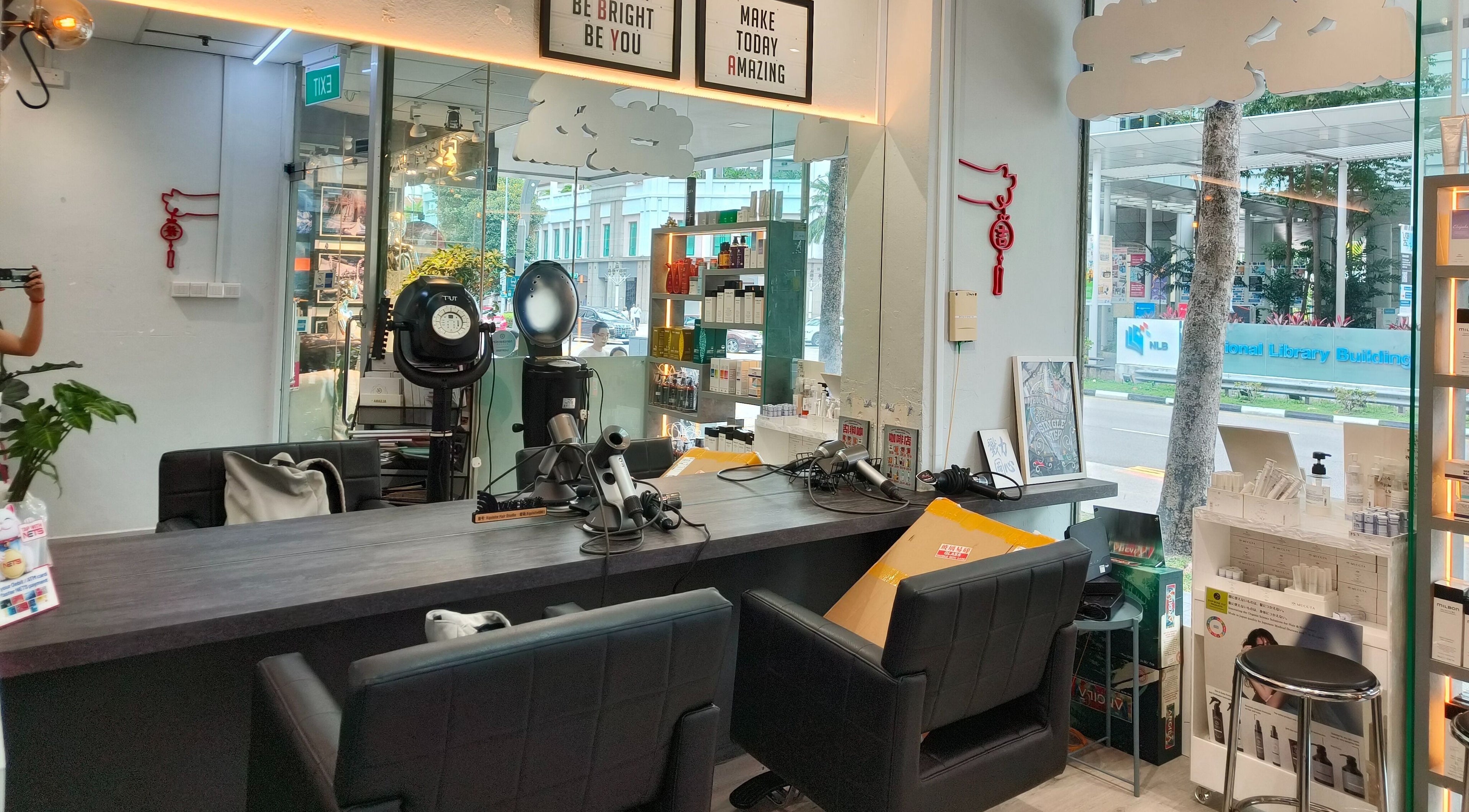 Interior view of X’quisite Hair Studio, Singapore, featuring stylish salon stations and modern decor.