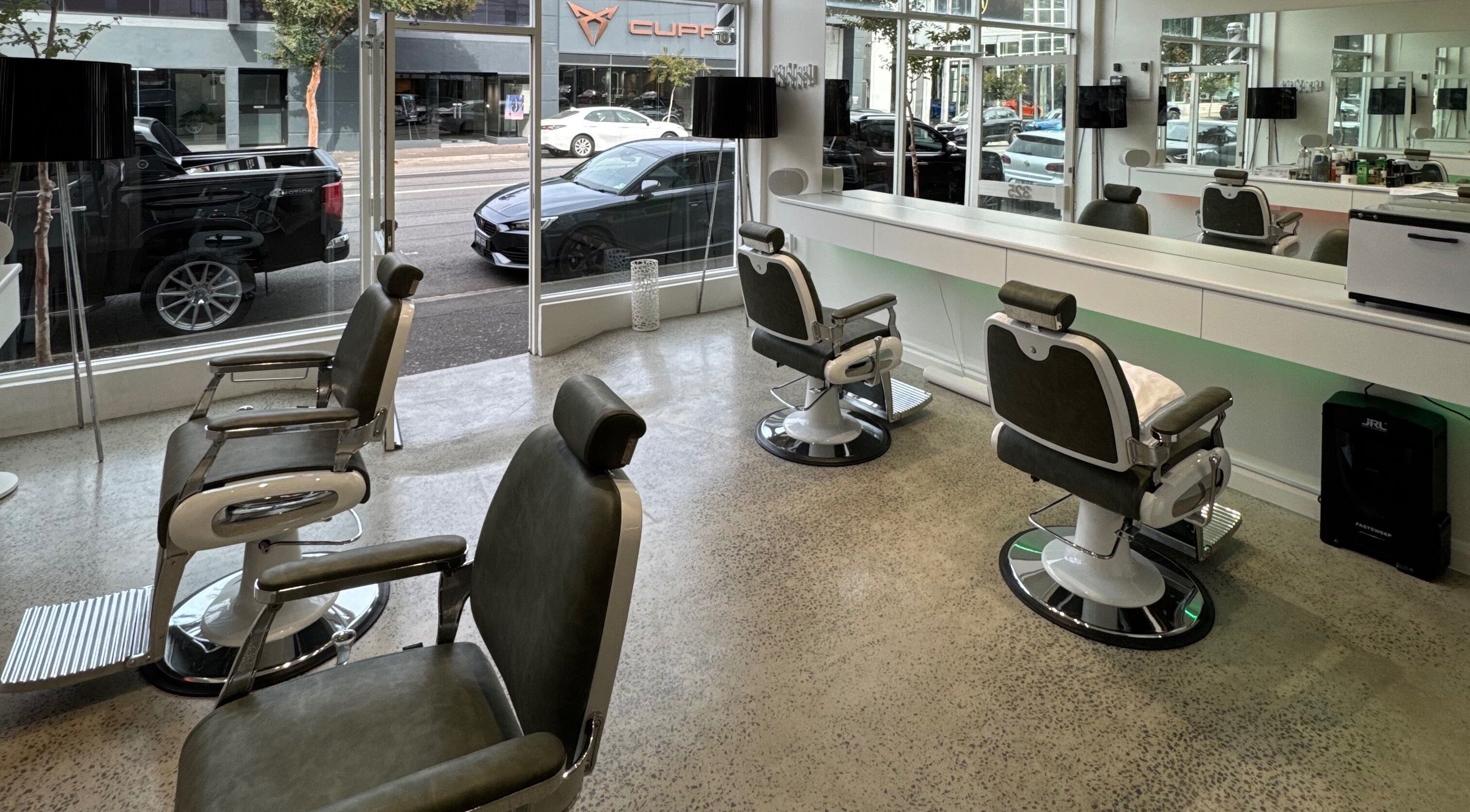 Modern barber chairs at Black Swan Barbers, Richmond, Victoria, AU, offering stylish grooming services.