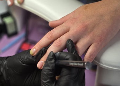 Manicure service at Just Jess Nails in Cheltenham, England, GB. Hands being painted by a technician.