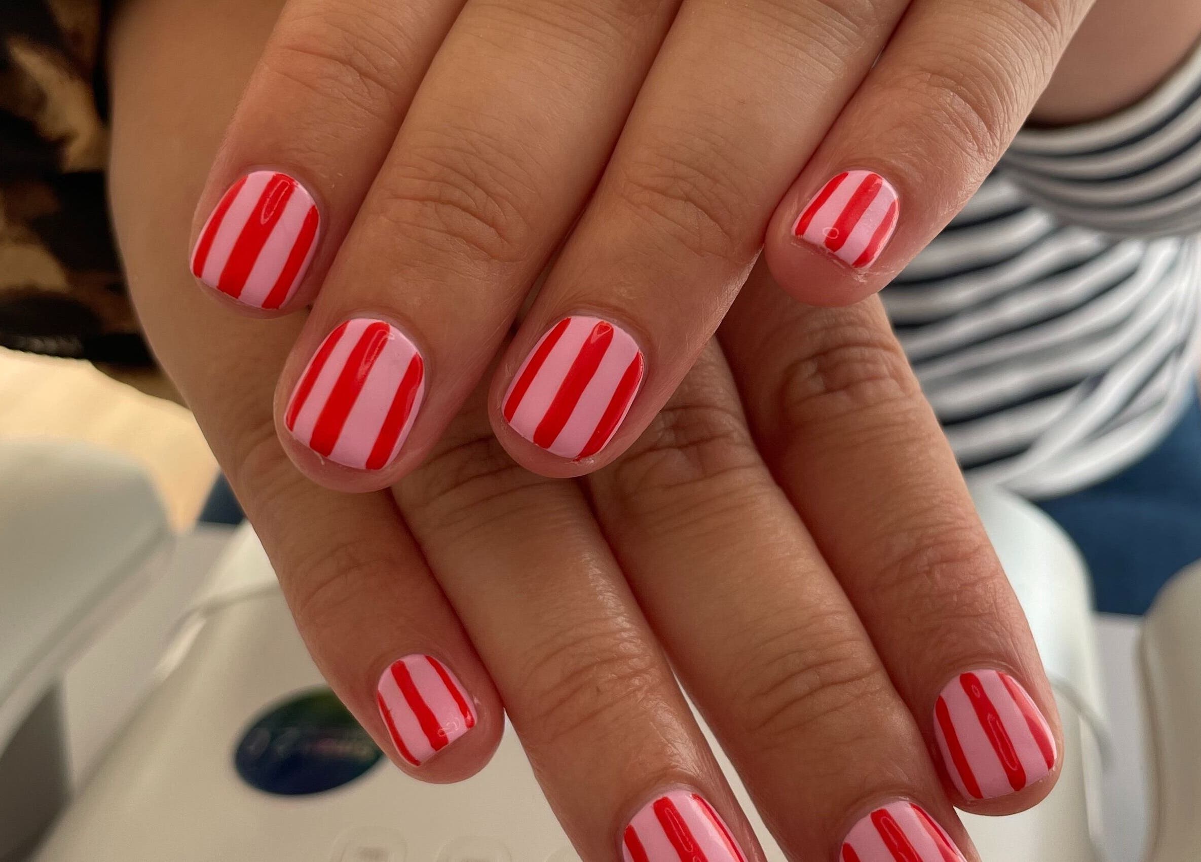 Red and white striped nails at Nails by Chloe in Marske-by-the-Sea, England, GB for a chic look.