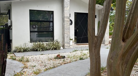 Entrance of Lavish Seven Beauty Bar in Annangrove, New South Wales, AU with modern design and greenery.