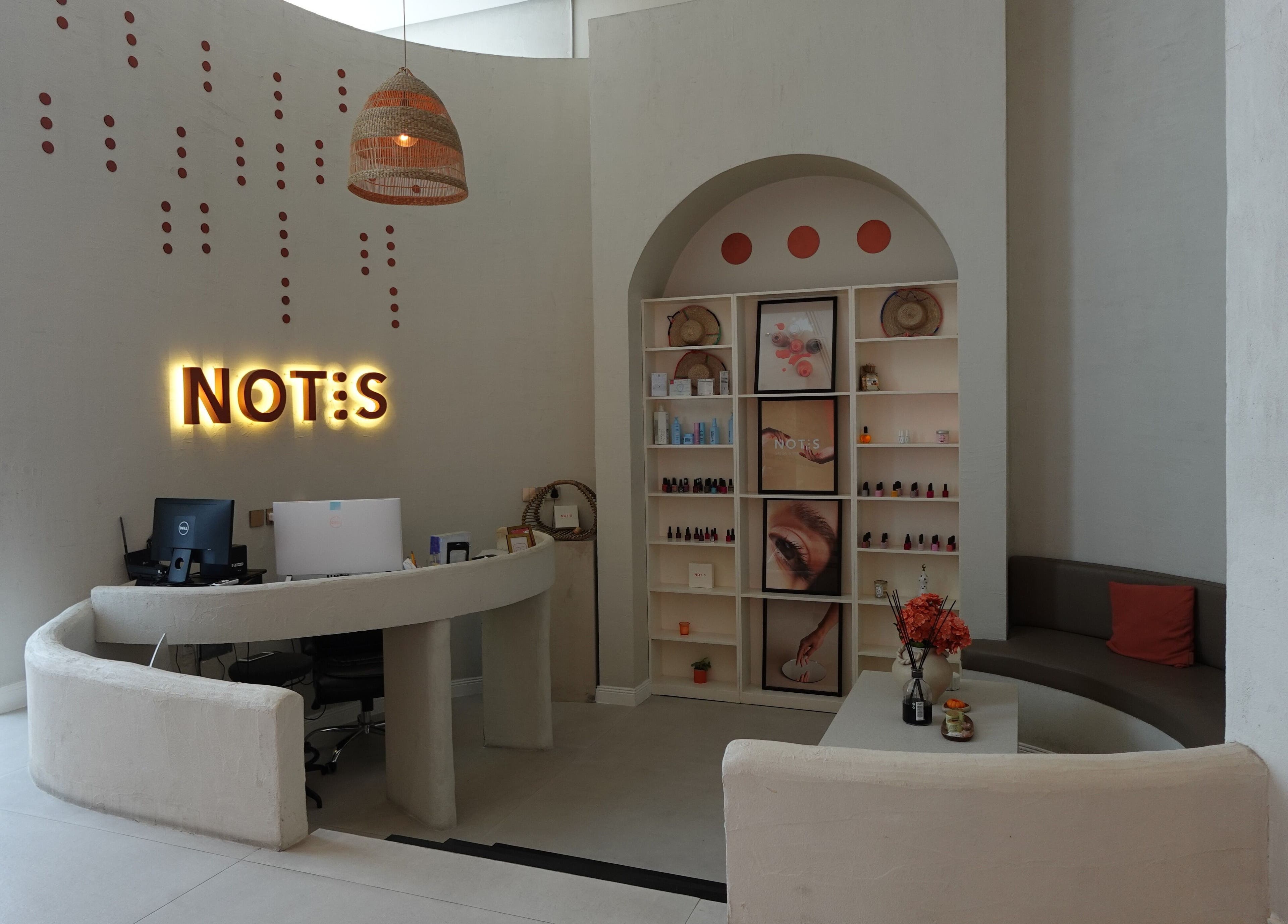 Reception area with neon sign at Notes Salon, Dammam, Eastern Province, SA, featuring modern decor.