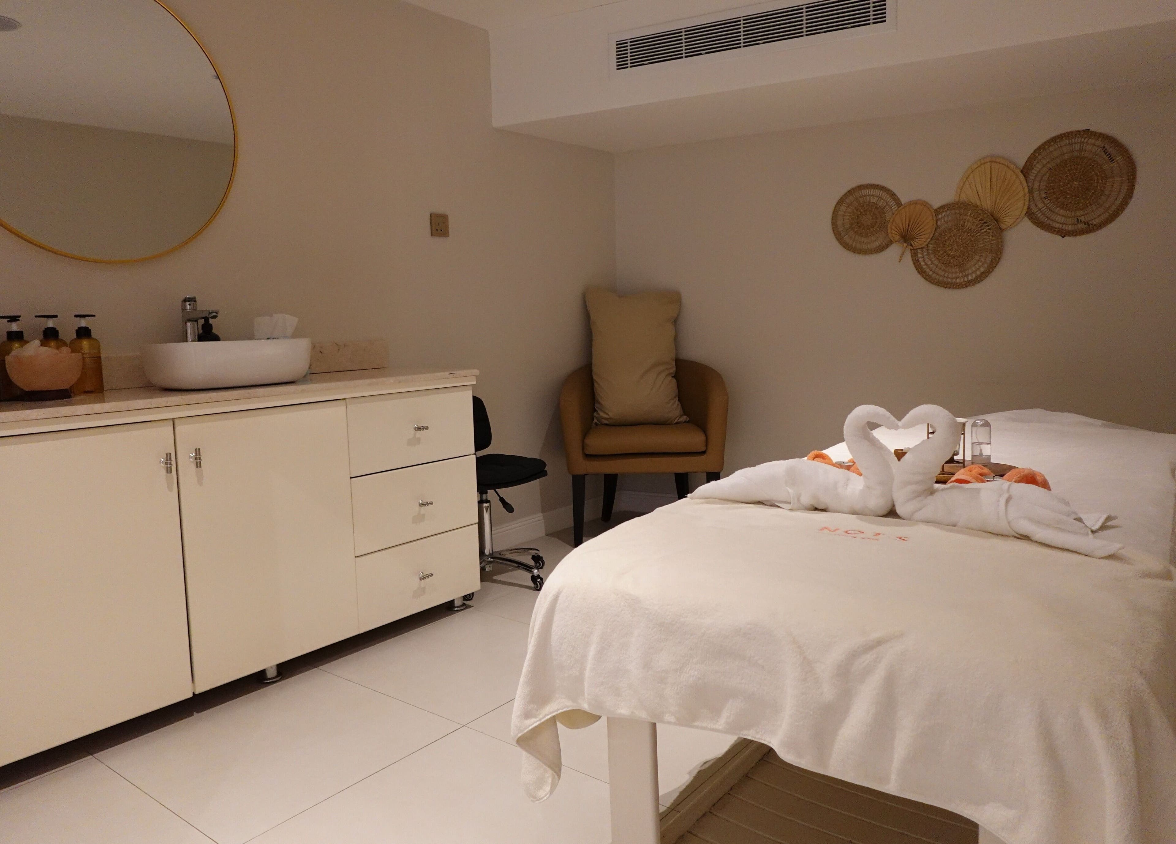 Calming spa room at Notes Salon, Dammam, Eastern Province, SA, with massage table and elegant decor.