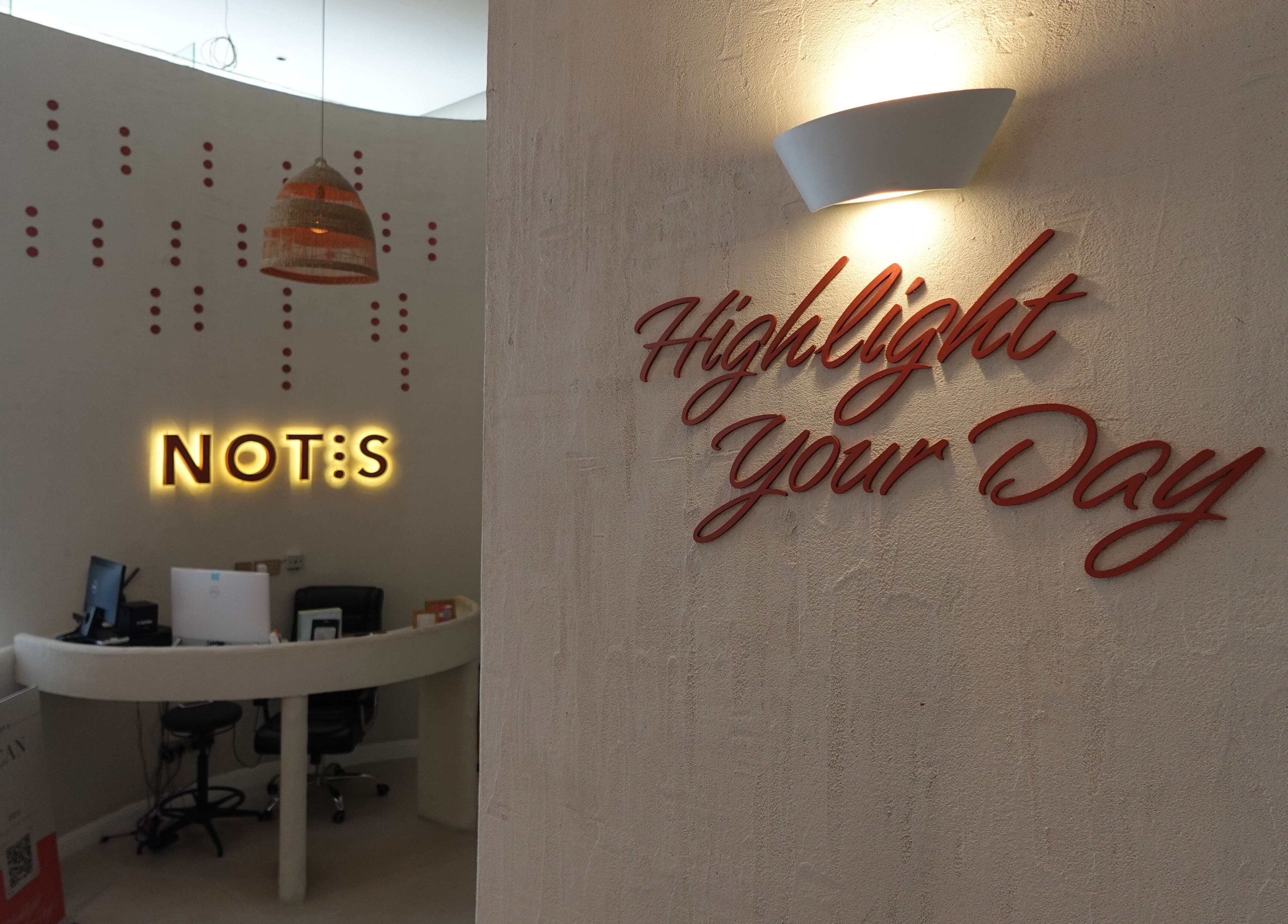 Reception area of Notes Salon in Dammam, Eastern Province, SA with illuminated signage.