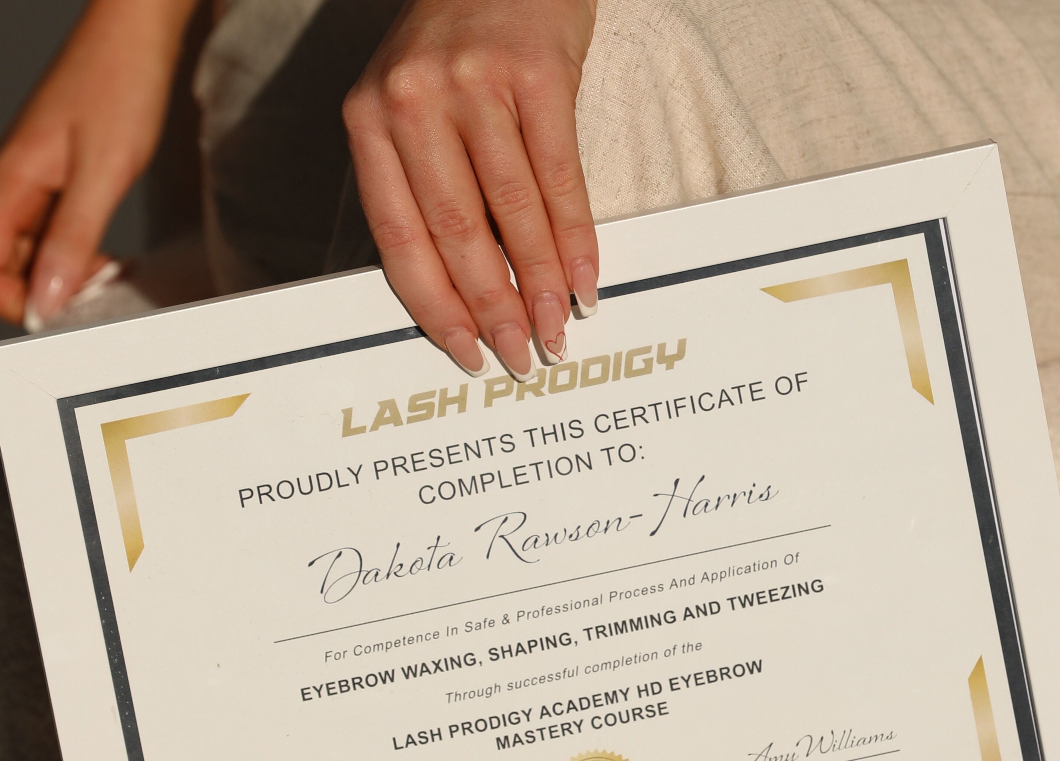 LuxLashNBeautyBar certificate of completion held by a hand in Watanobbi, New South Wales, AU.