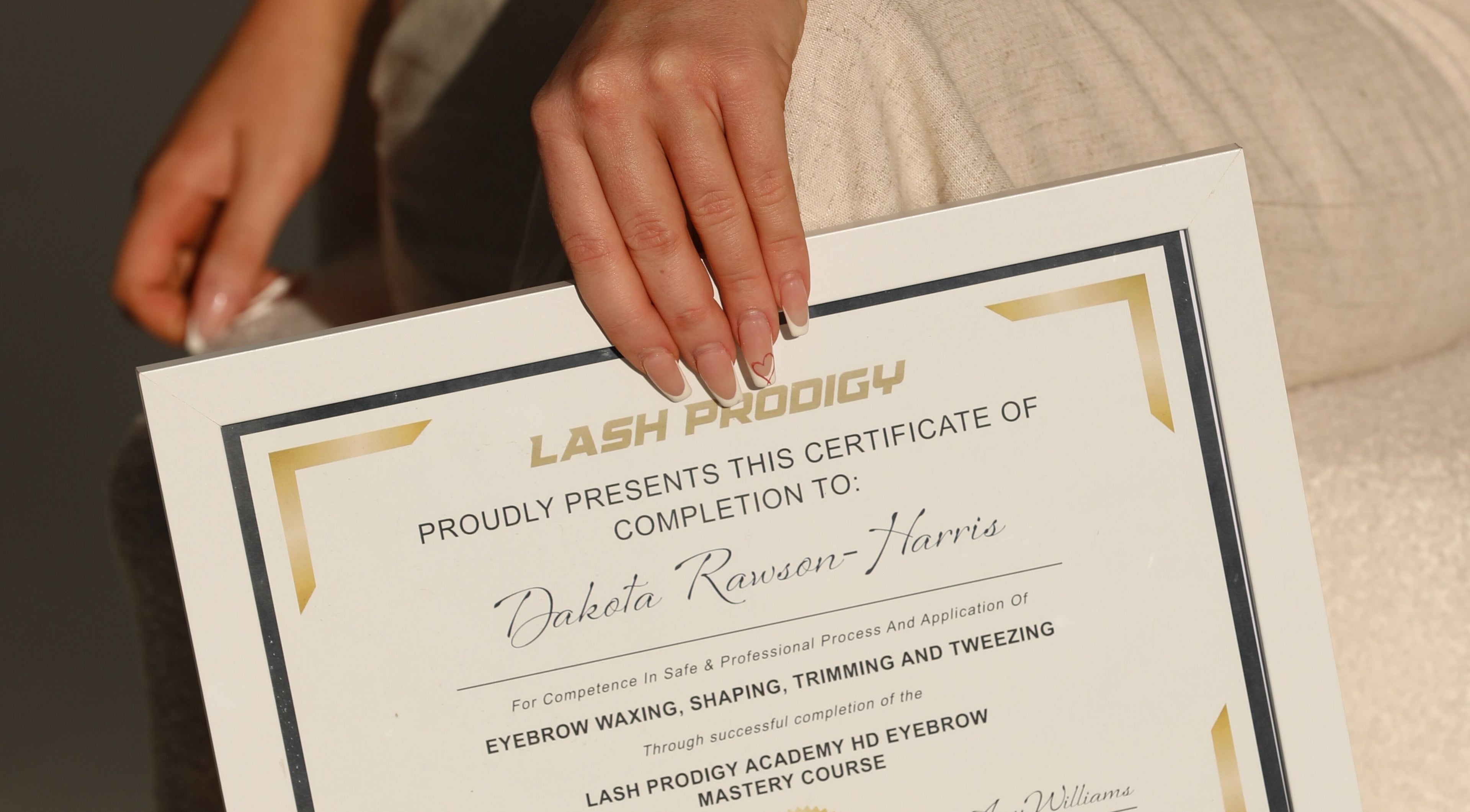 LuxLashNBeautyBar certificate of completion held by a hand in Watanobbi, New South Wales, AU.