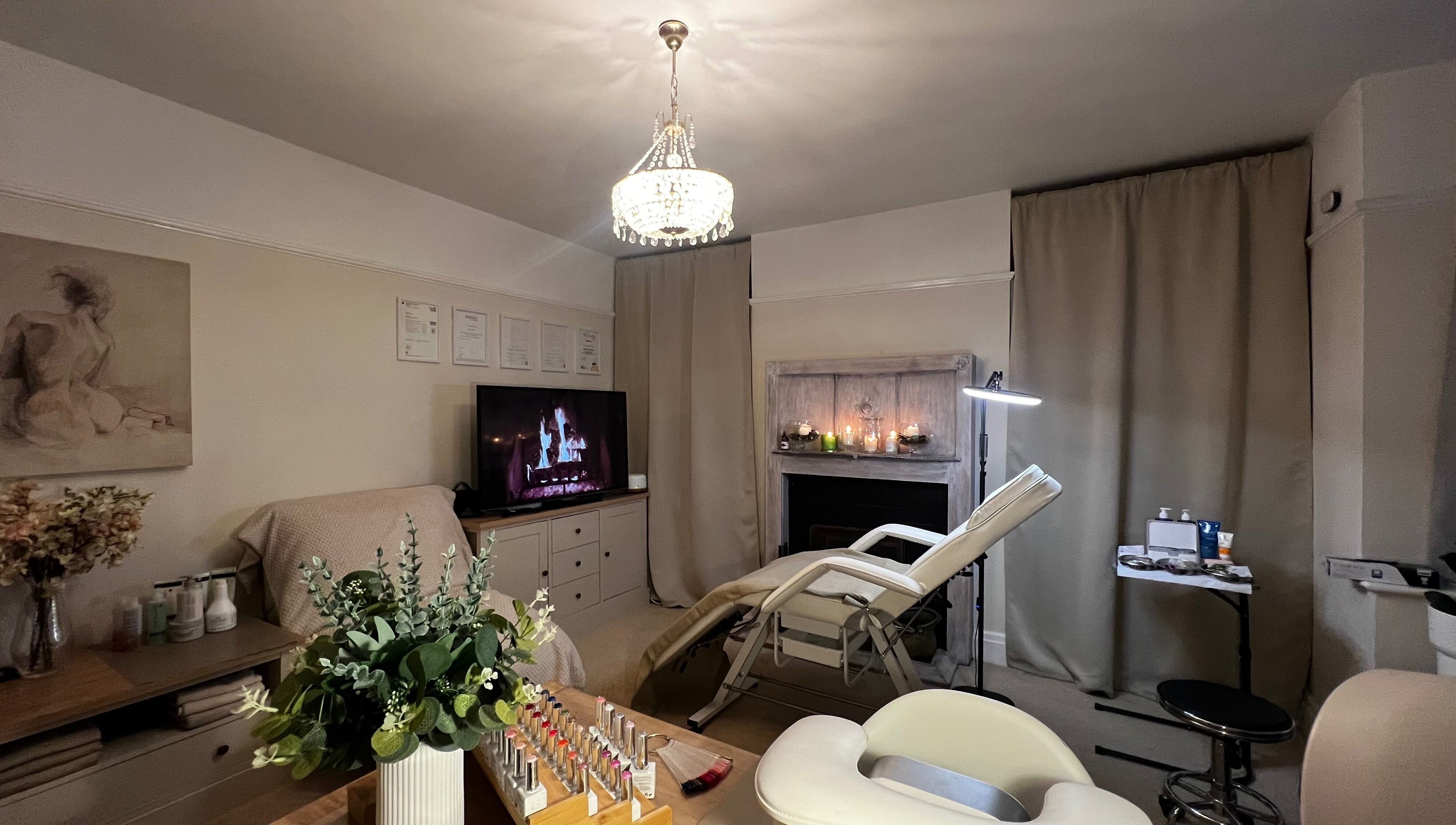 Luxurious treatment room at Lumiere Beauty, Cambridge, England, GB with spa bed, art, and warm lighting.