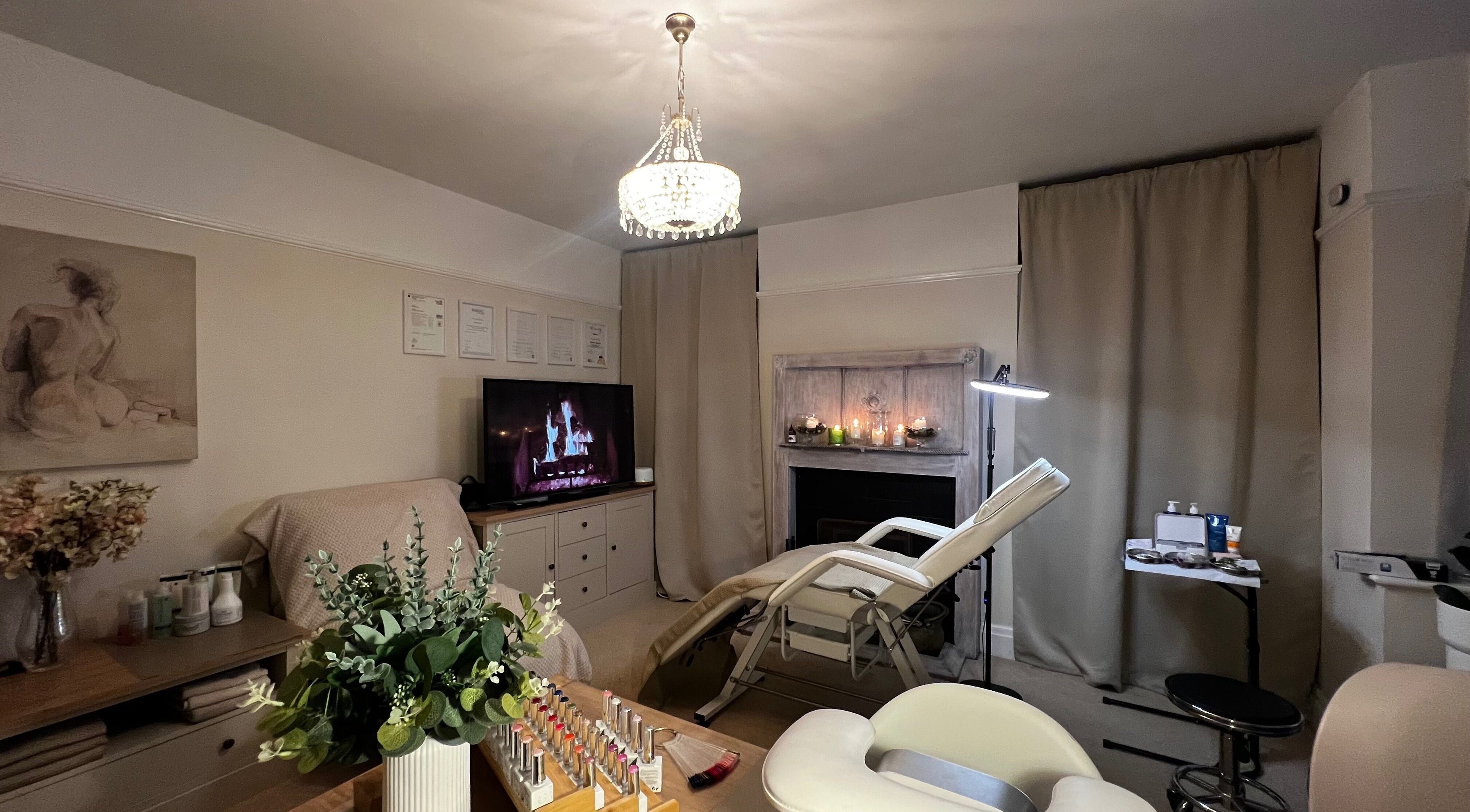 Luxurious treatment room at Lumiere Beauty, Cambridge, England, GB with spa bed, art, and warm lighting.