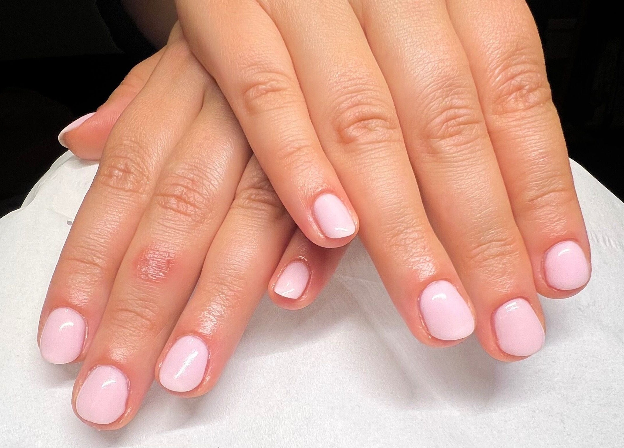 Freshly manicured hands at Lumiere Beauty, Cambridge, England, GB, showcasing elegant nail artistry.