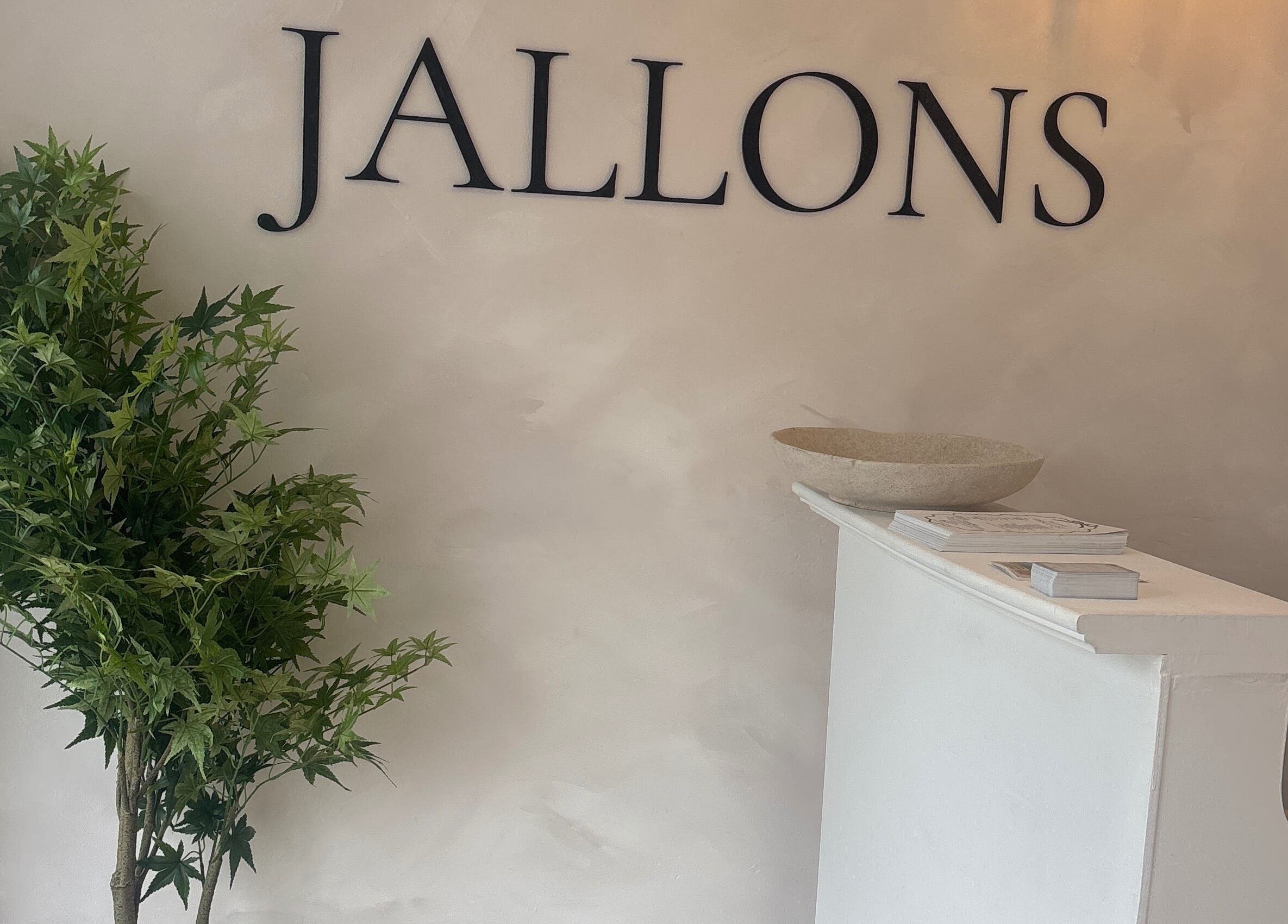 Elegant reception desk at Kari Beauty in Clifton, England, GB, adorned with greenery and modern decor.