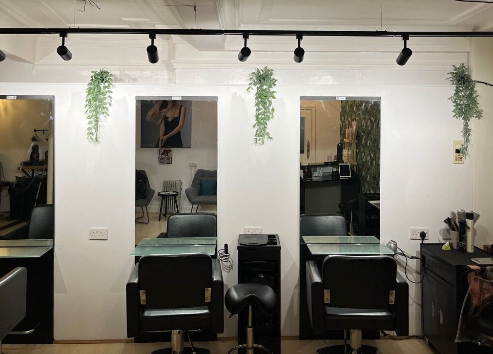 Modern salon interior at Niamh Monaghan Hair, Norwich, England, GB. Sleek styling stations and contemporary decor.