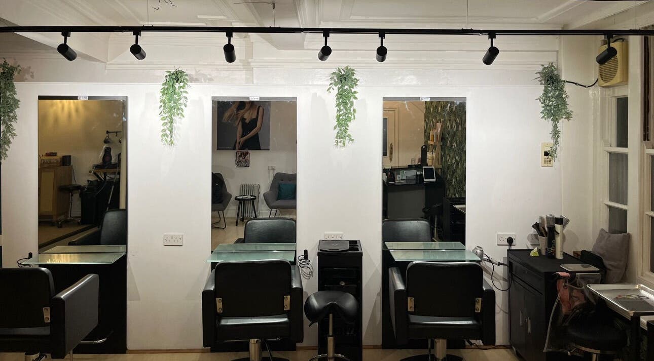 Modern salon interior at Niamh Monaghan Hair, Norwich, England, GB. Sleek styling stations and contemporary decor.