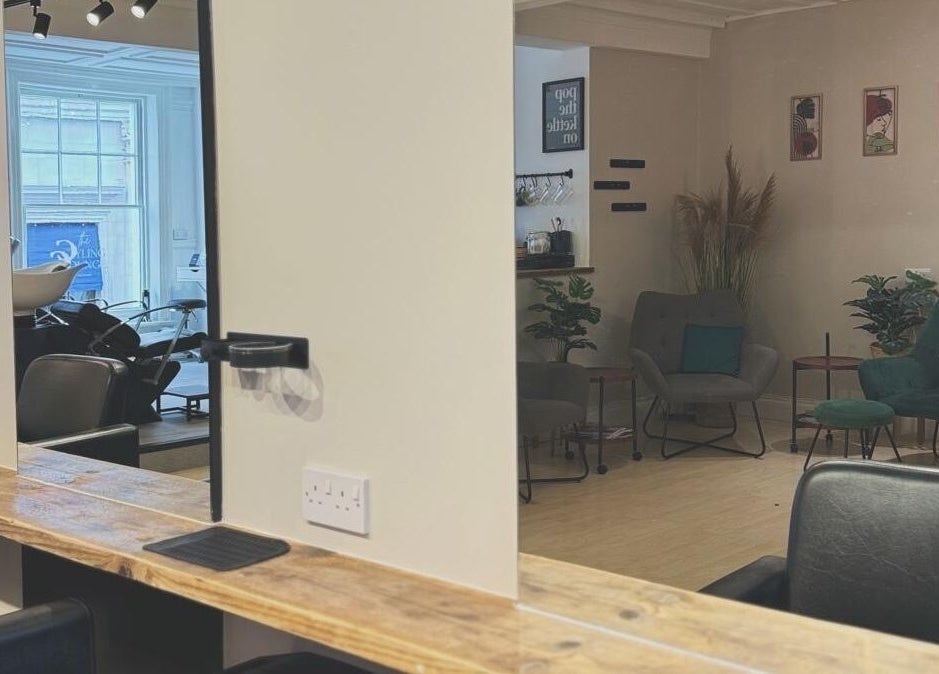 Modern salon interior at Niamh Monaghan Hair, Norwich, England, GB, showcasing stylish seating and hair stations.