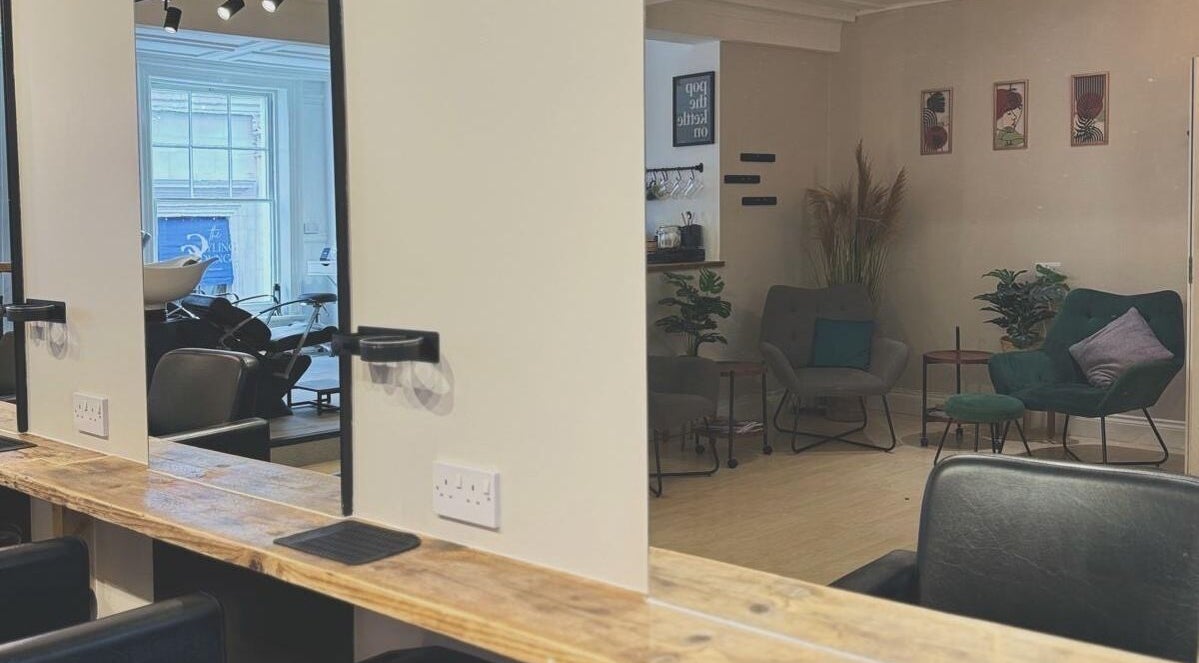 Modern salon interior at Niamh Monaghan Hair, Norwich, England, GB, showcasing stylish seating and hair stations.