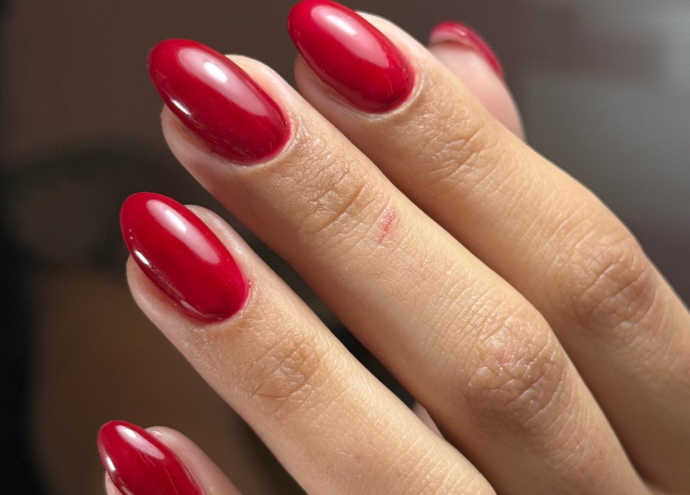 Glossy red nails at Delmarrr.studio, Toa Alta, Bayamón, PR showcasing expert manicure finesse.