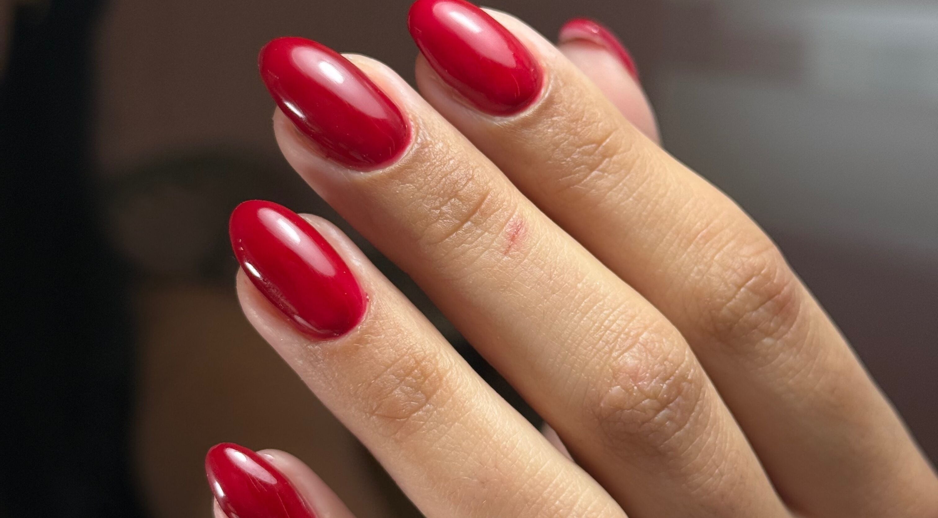 Glossy red nails at Delmarrr.studio, Toa Alta, Bayamón, PR showcasing expert manicure finesse.