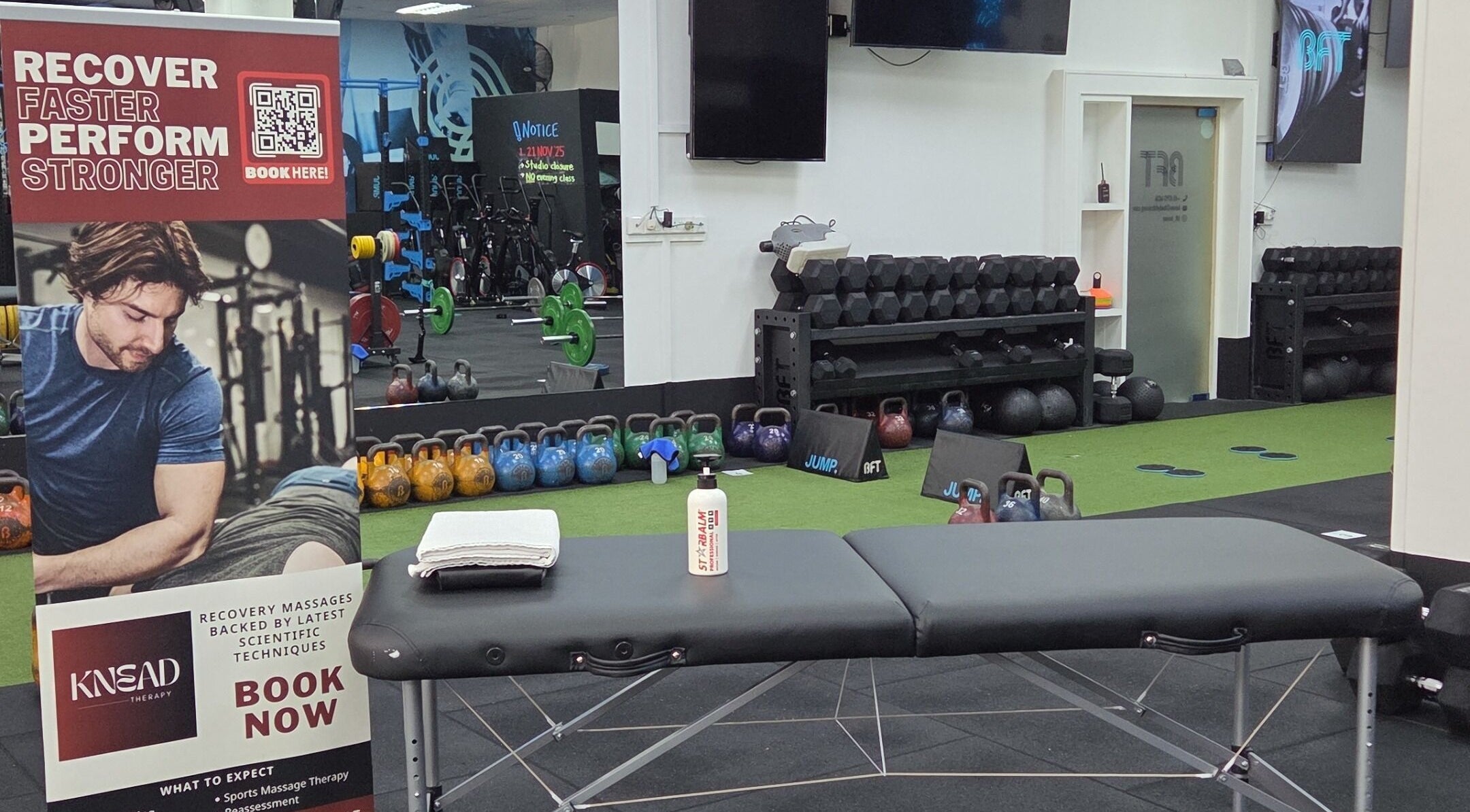 Massage table and gym equipment at Knead Therapy Kovan in Singapore, SG, promoting recovery and performance.