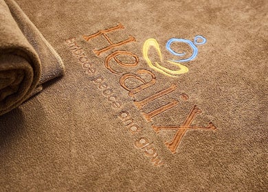 Plush towel at Healix Spa & Massage Therapy, St Leonards, New South Wales, AU, embroidered with logo.