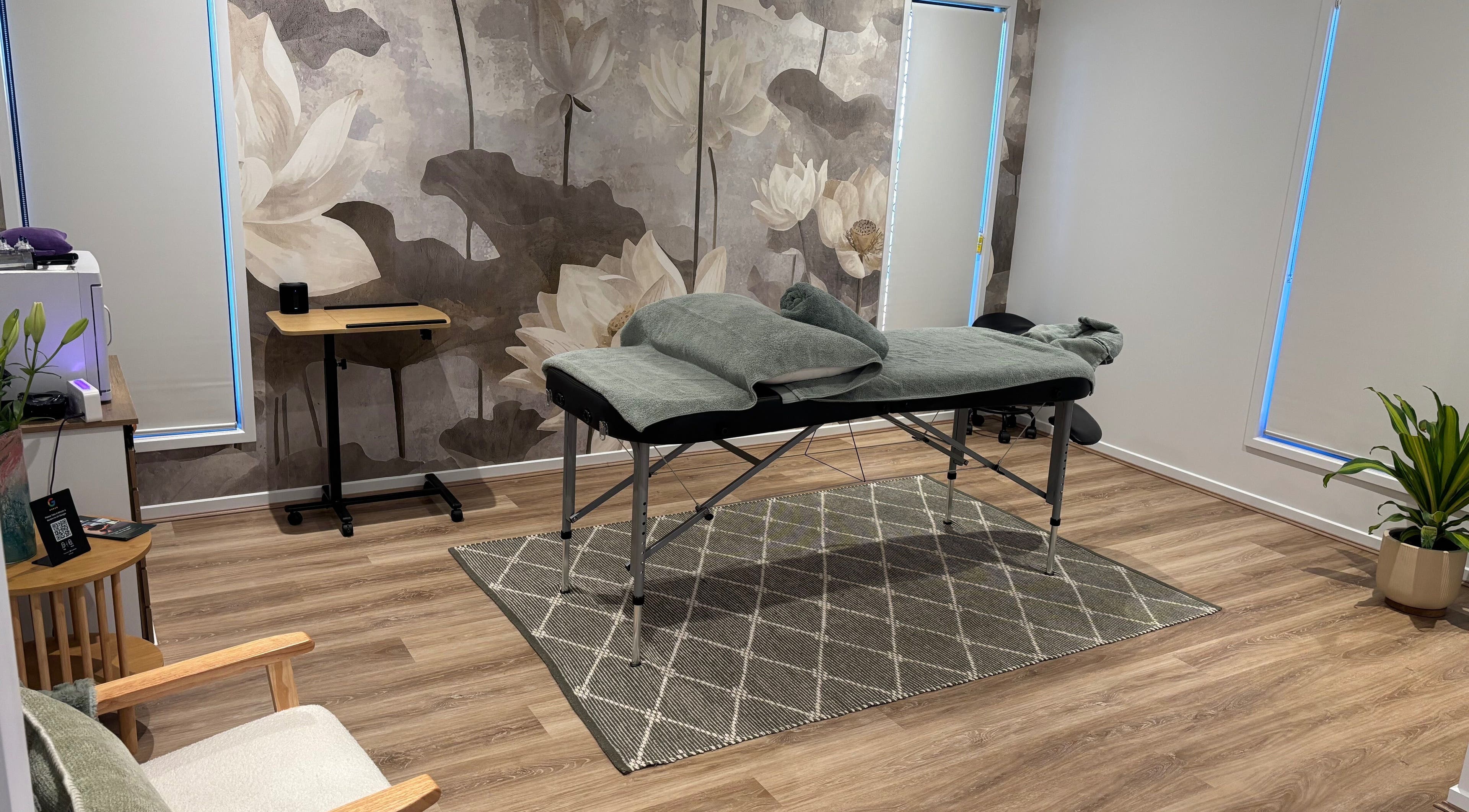 Relaxing massage room at Bargara Bliss in Bargara, Queensland, AU, featuring a treatment bed and calming decor.