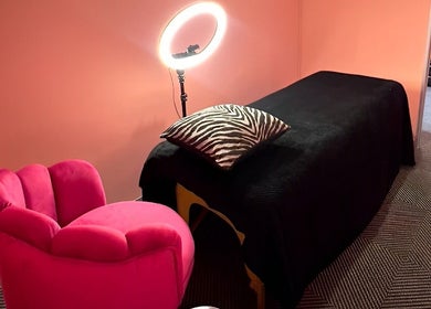 Elegant treatment room at Peaches Beauty Bar Midrand, Midrand, Gauteng, ZA, featuring pink decor and zebra pillow.