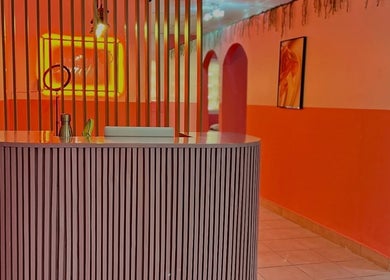 Modern reception at Peaches Beauty Bar, Edenvale, Gauteng, ZA with vibrant decor and neon lighting.