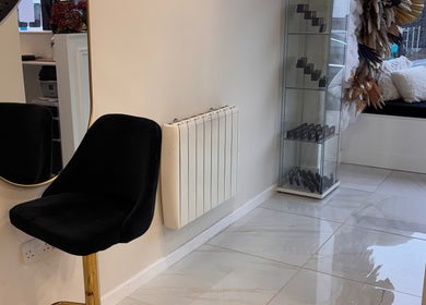 Elegant beauty area at Beautybyanna Jane, Leyland, England, GB with black chair and decorative glass shelf.