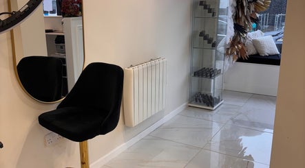 Elegant beauty area at Beautybyanna Jane, Leyland, England, GB with black chair and decorative glass shelf.