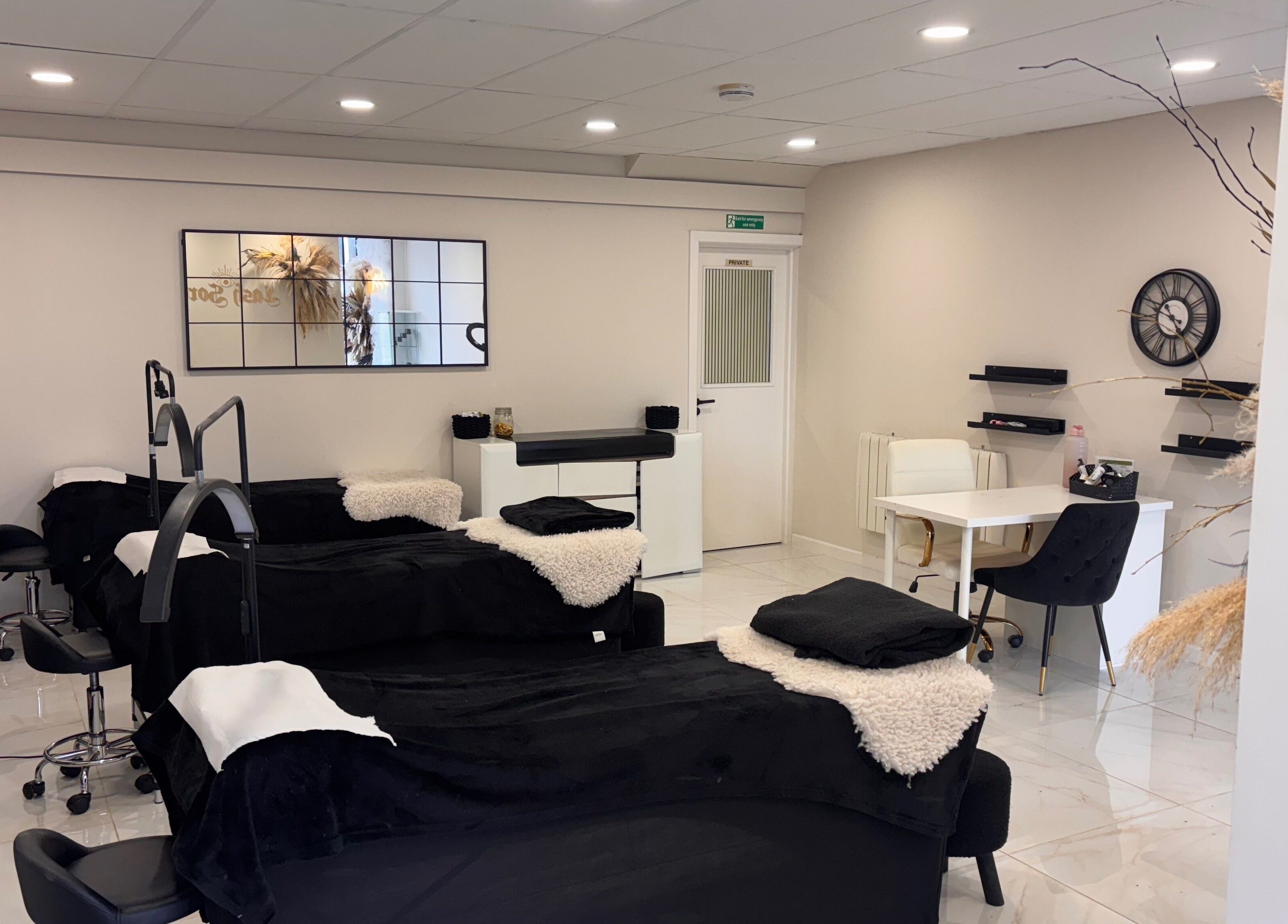 Beautybyanna Jane's inviting treatment room in Leyland, England, GB with plush black beds and modern decor.