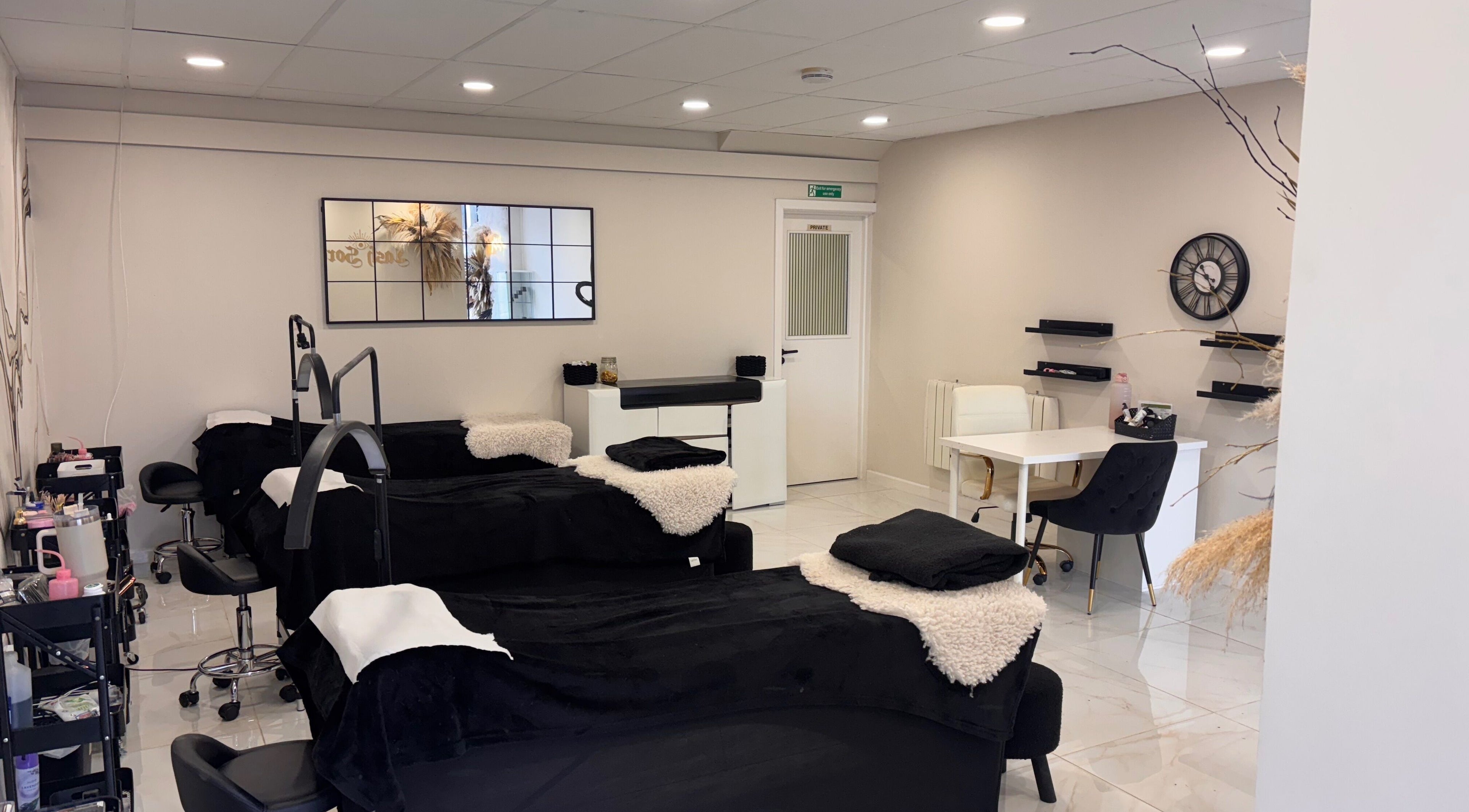 Beautybyanna Jane's inviting treatment room in Leyland, England, GB with plush black beds and modern decor.