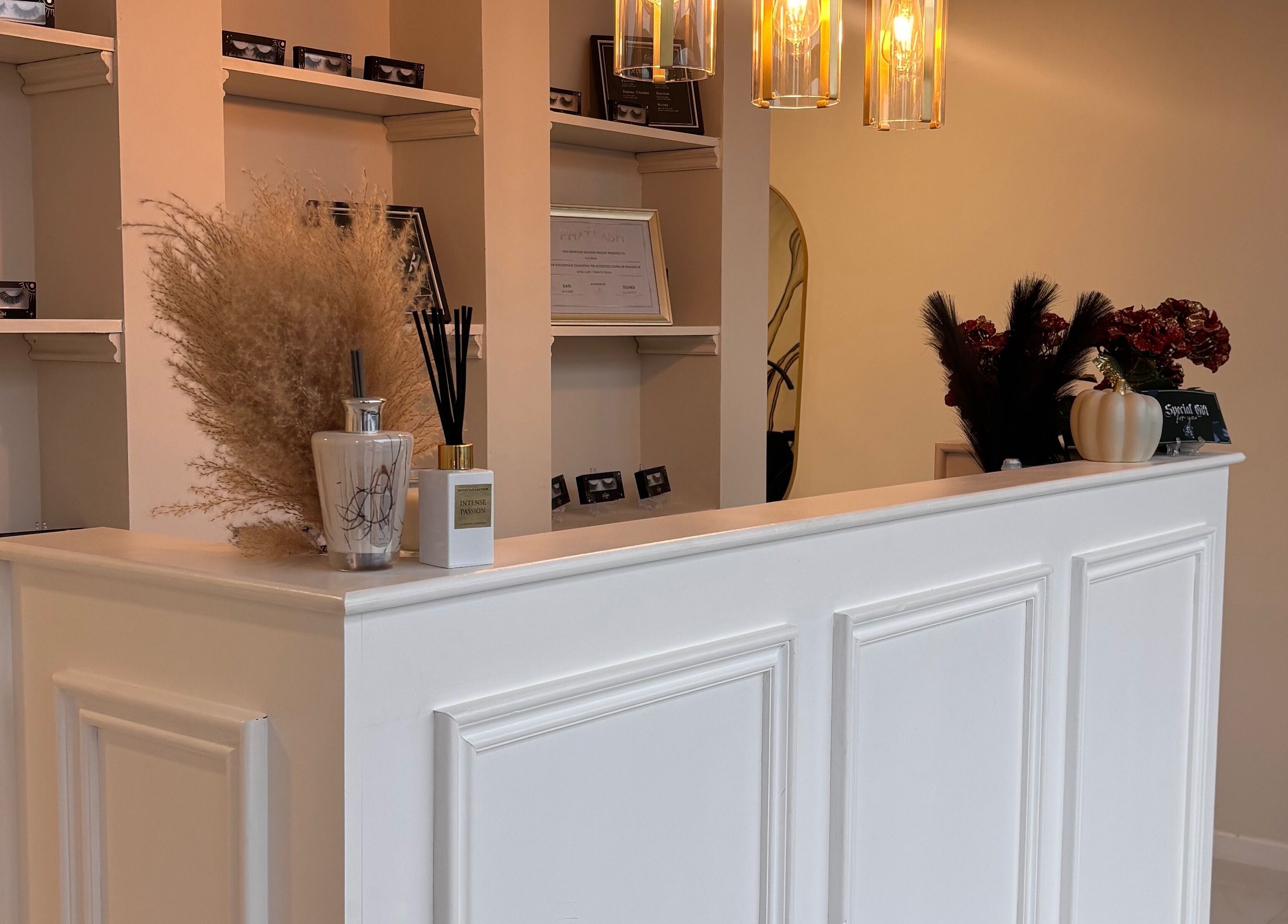Reception desk at Beautybyanna Jane in Leyland, England, GB, featuring stylish decor and warm lighting.