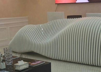 Sleek reception desk at Vivo Clinic Dubai, Dubai, AE featuring modern, wave-like design for an inviting atmosphere.