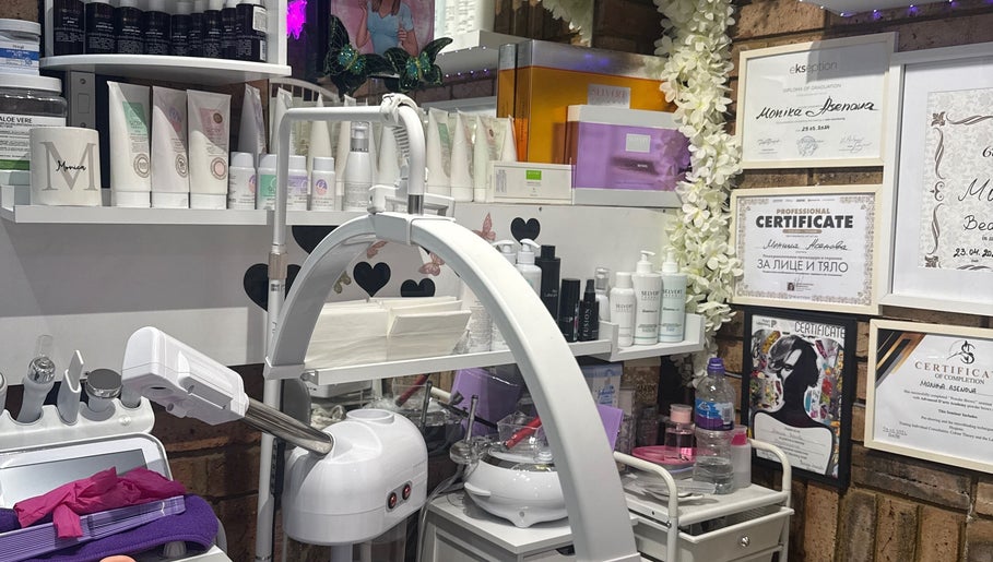 Monica’s Beauty Lounge treatment room featuring products and certificates in London, England, GB.