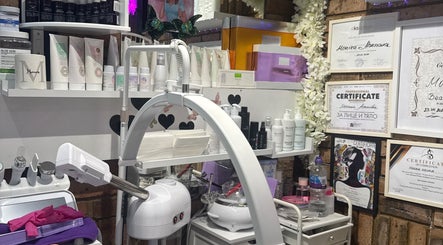 Monica’s Beauty Lounge treatment room featuring products and certificates in London, England, GB.