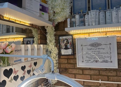 Intricate beauty shelf display at Monica’s Beauty Lounge, London, England, GB with certificates and products.
