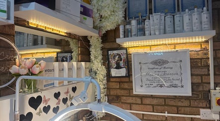 Intricate beauty shelf display at Monica’s Beauty Lounge, London, England, GB with certificates and products.