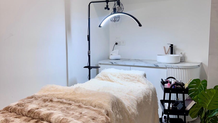 Cozy treatment room at Bespoke Beauty, Caringbah, New South Wales, AU, featuring a plush bed and modern decor.