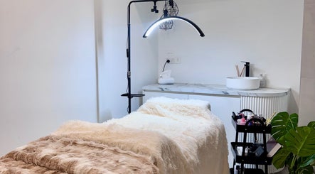 Cozy treatment room at Bespoke Beauty, Caringbah, New South Wales, AU, featuring a plush bed and modern decor.