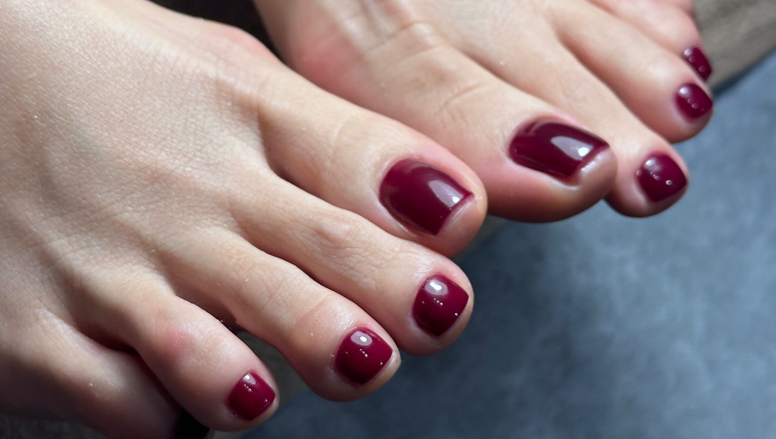 Stylish burgundy pedicure at Studio April, Melbourne, Victoria, AU, showcasing professional nail care.