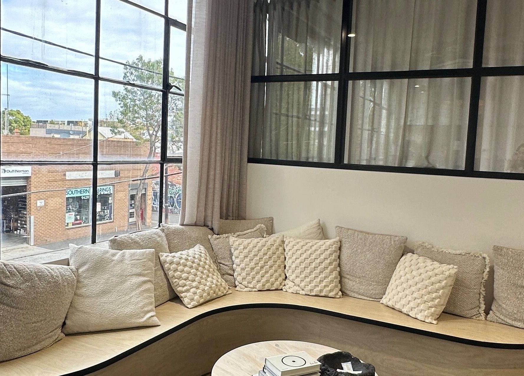 Inviting window seating with plush cushions at Studio April, Melbourne, Victoria, AU offering cozy relaxation.